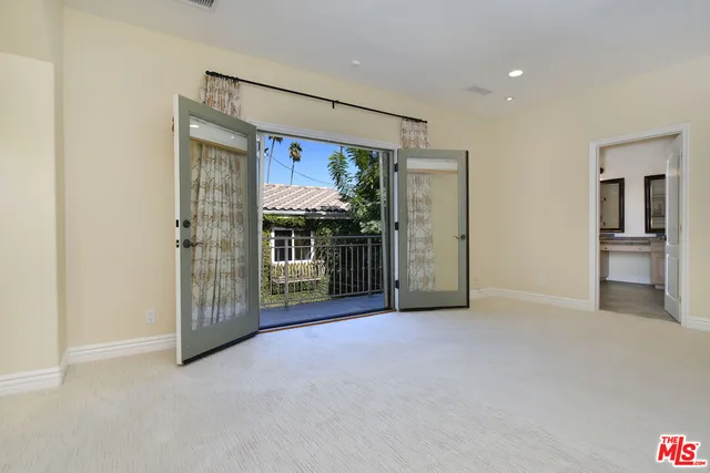 a view of a patio with table and chairs and potted plants