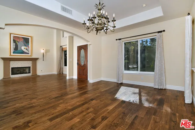 a view of an empty room with a chandelier