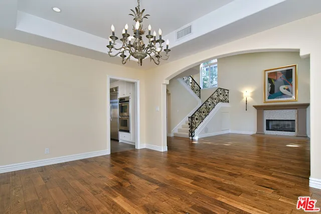 a kitchen with granite countertop a oven and cabinets