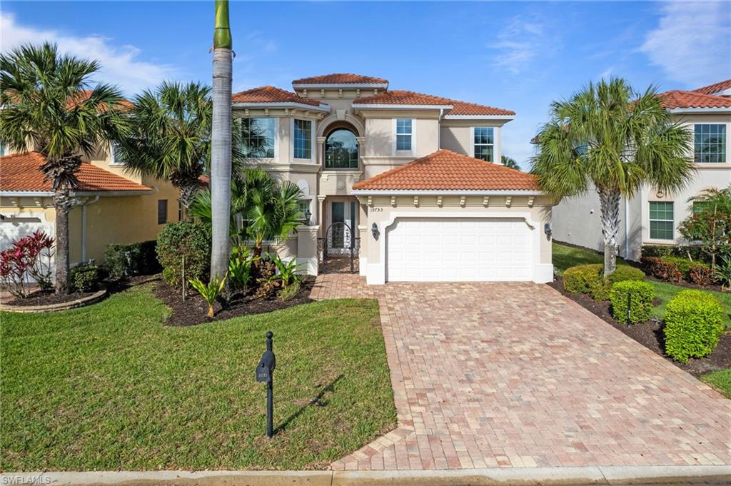 19753 Tesoro Way Estero, FL 33967 - Photo 27 of 47 a front view of a house with a yard