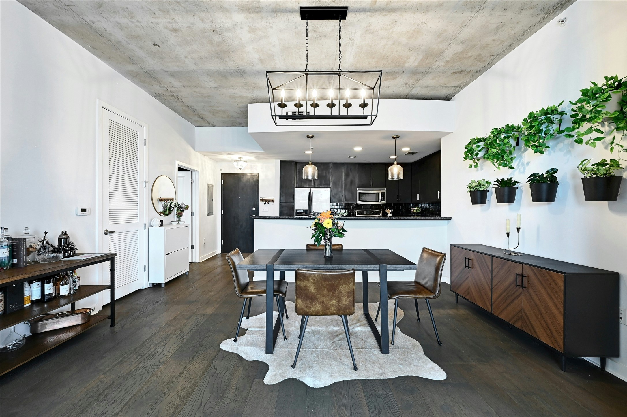 360 Nueces Street, Unit 1809 Austin, TX 78701 - Photo 6 of 25 Open-concept dining area featuring dark wood-finish flooring and a concrete ceiling