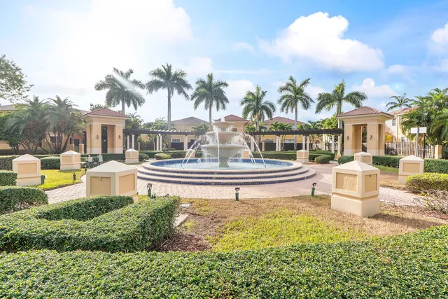 a building exterior with palm trees