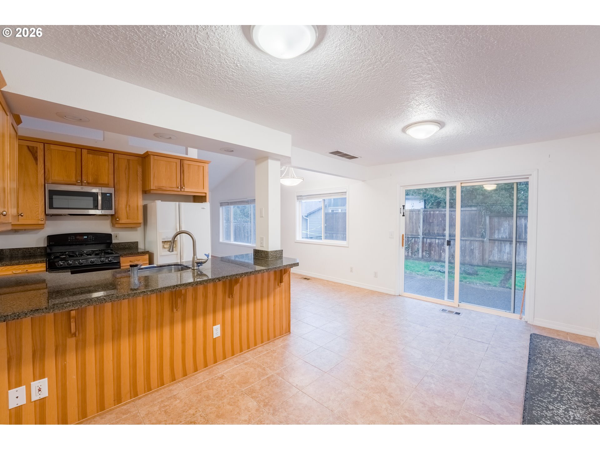2320 Northeast Rene Avenue Gresham, OR 97030 - Photo 11 of 25 a kitchen with stainless steel appliances granite countertop a stove a sink and a microwave