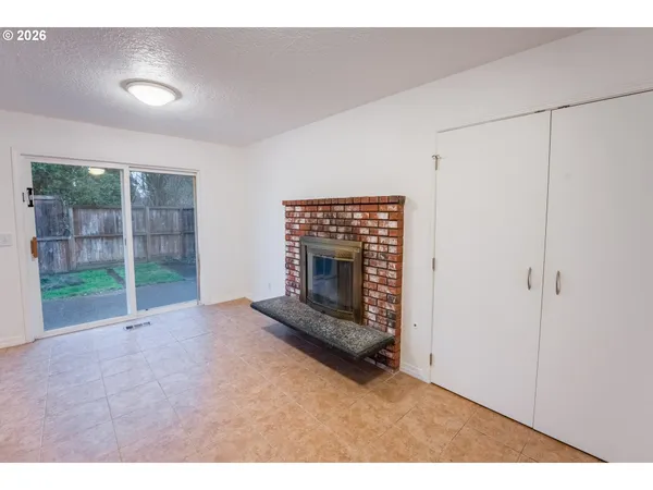 a view of an empty room with a fireplace