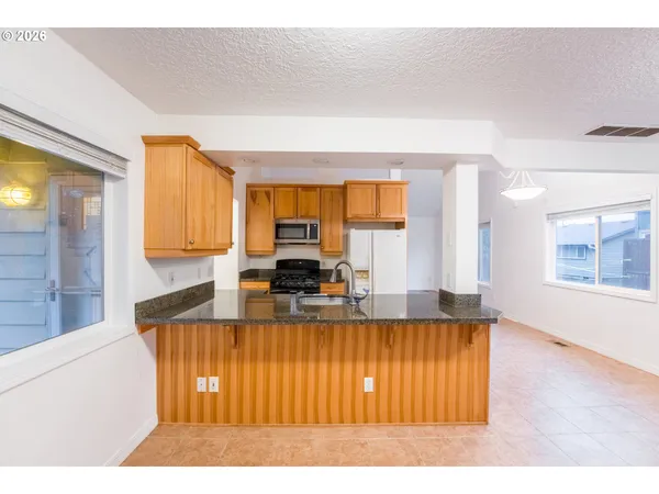 a kitchen with kitchen island granite countertop a sink and a counter top space