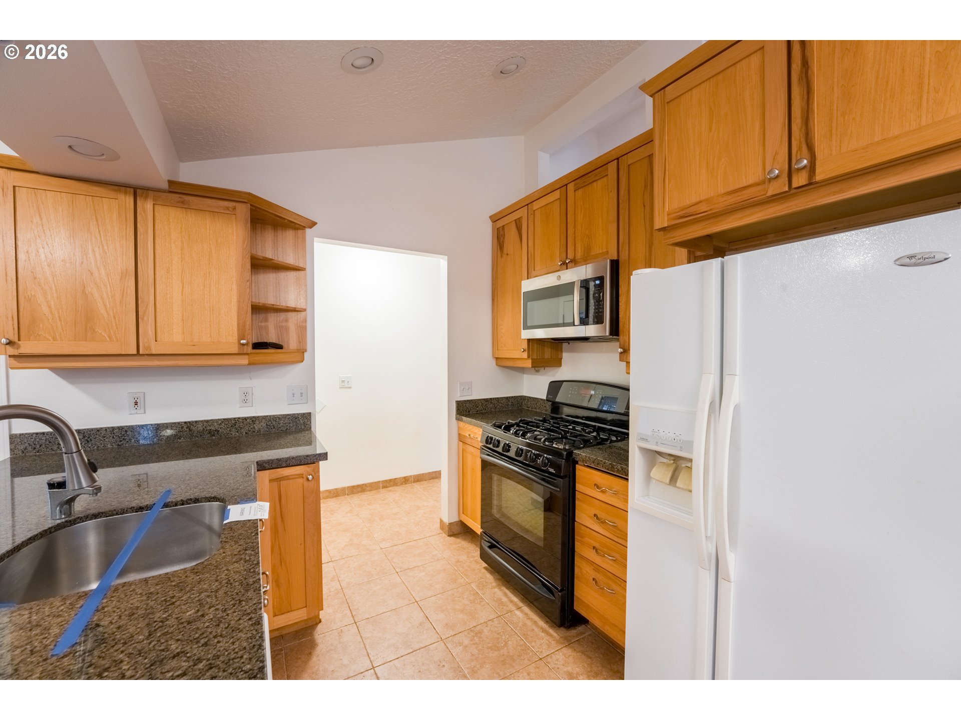 2320 Northeast Rene Avenue Gresham, OR 97030 - Photo 15 of 25 a kitchen with stainless steel appliances granite countertop a sink stove and refrigerator