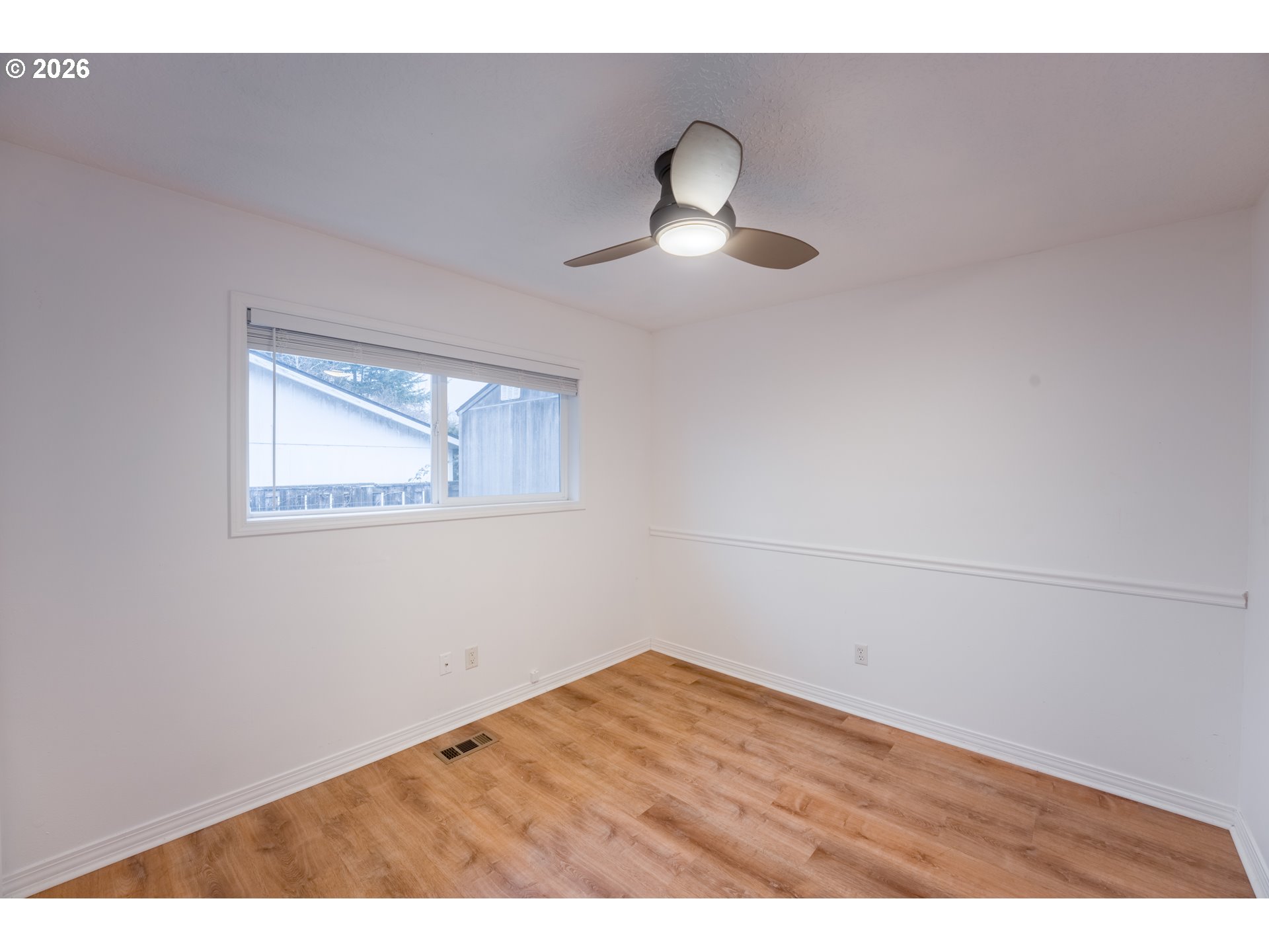 2320 Northeast Rene Avenue Gresham, OR 97030 - Photo 20 of 25 a view of an empty room with wooden floor and a window
