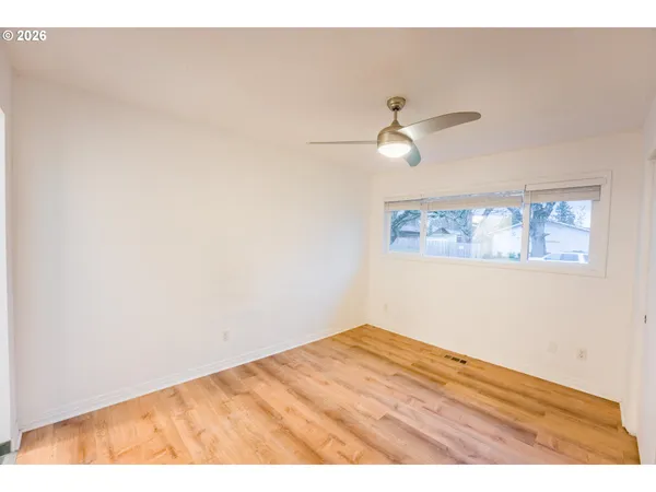 a view of empty room with ceiling fan