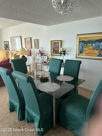 a view of a dining room with furniture and a potted plant