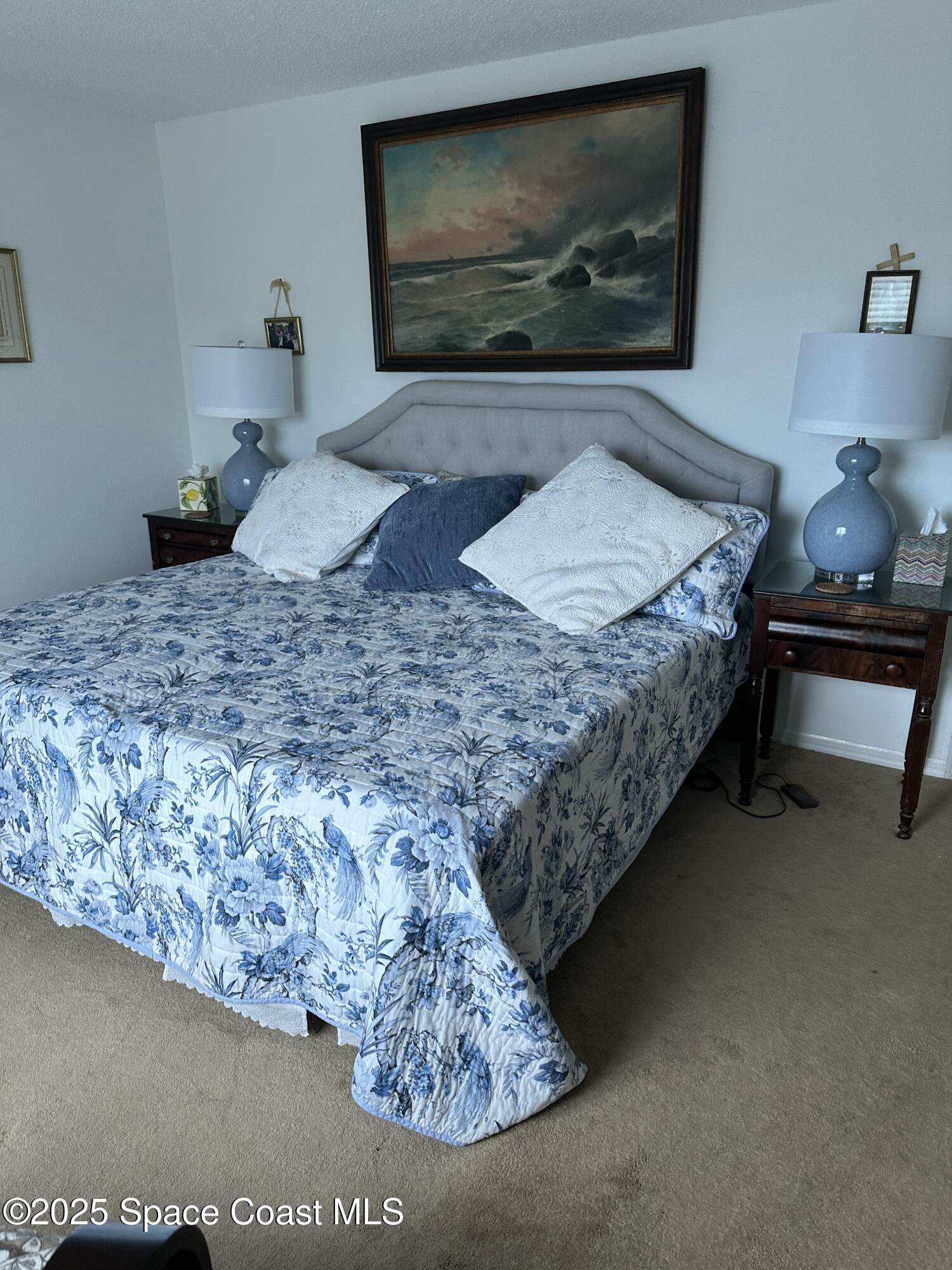 3170 North Atlantic Avenue, Unit 307 Cocoa Beach, FL 32931 - Photo 6 of 12 a living room with furniture and a flat screen tv