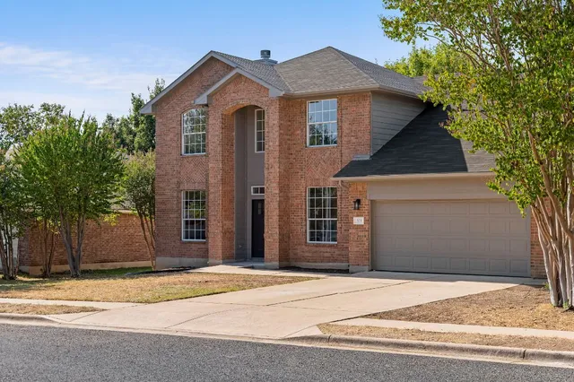 a front view of a house with a yard and garage