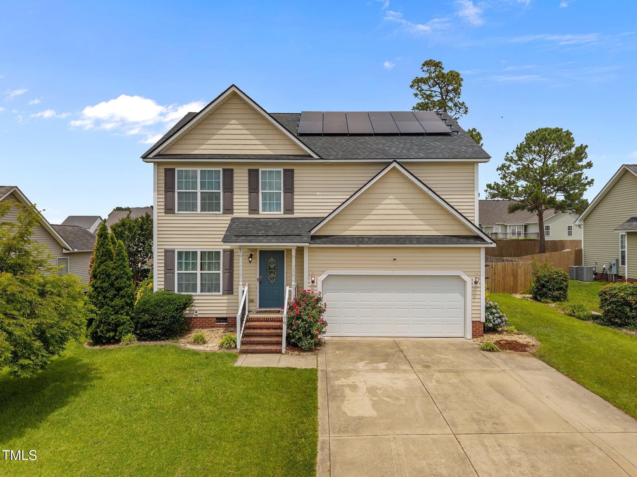 a front view of a house with a yard and garage