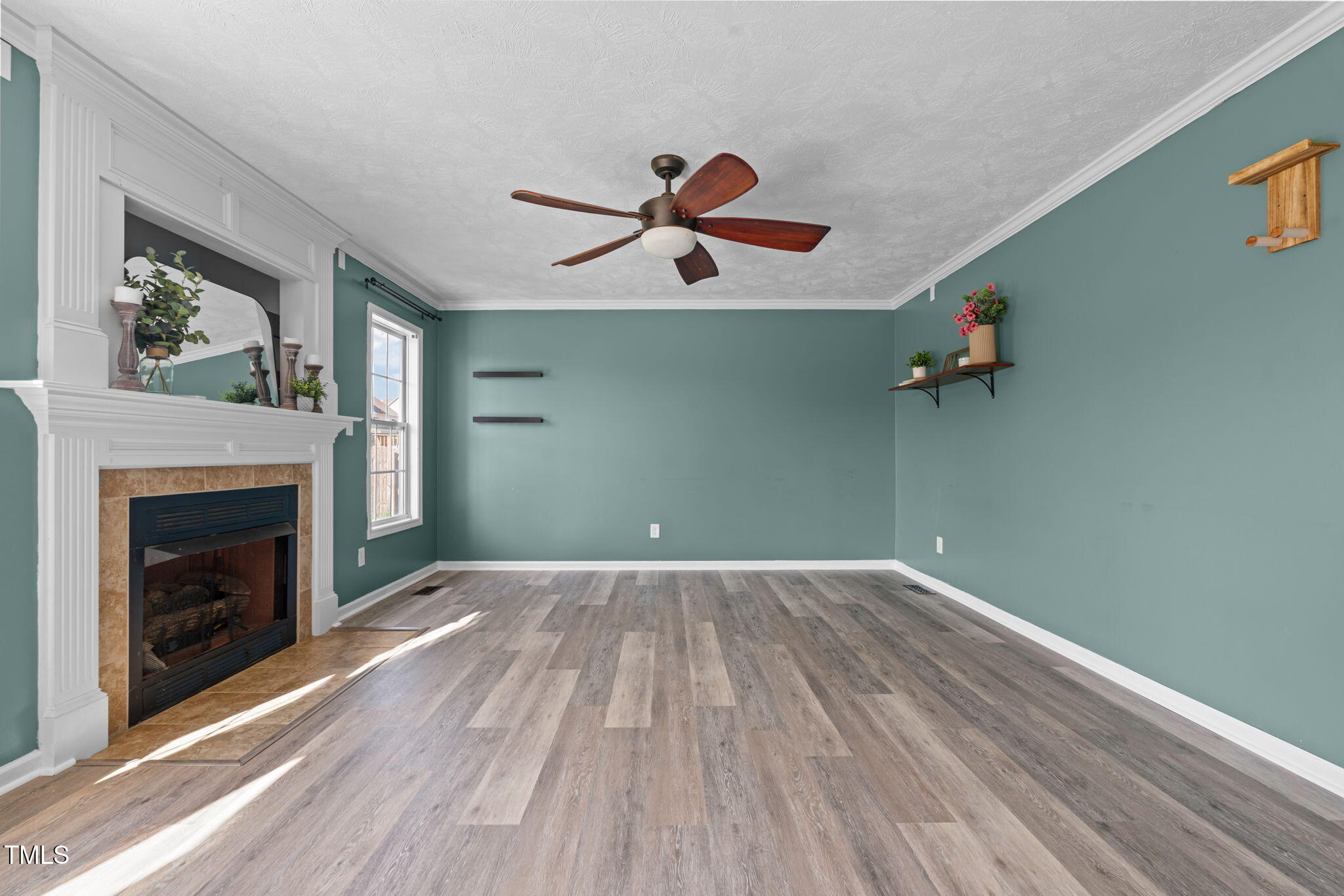 76 Haywood Street Spring Lake, NC 28390 - Photo 11 of 28 wooden floor in an empty room with a fireplace