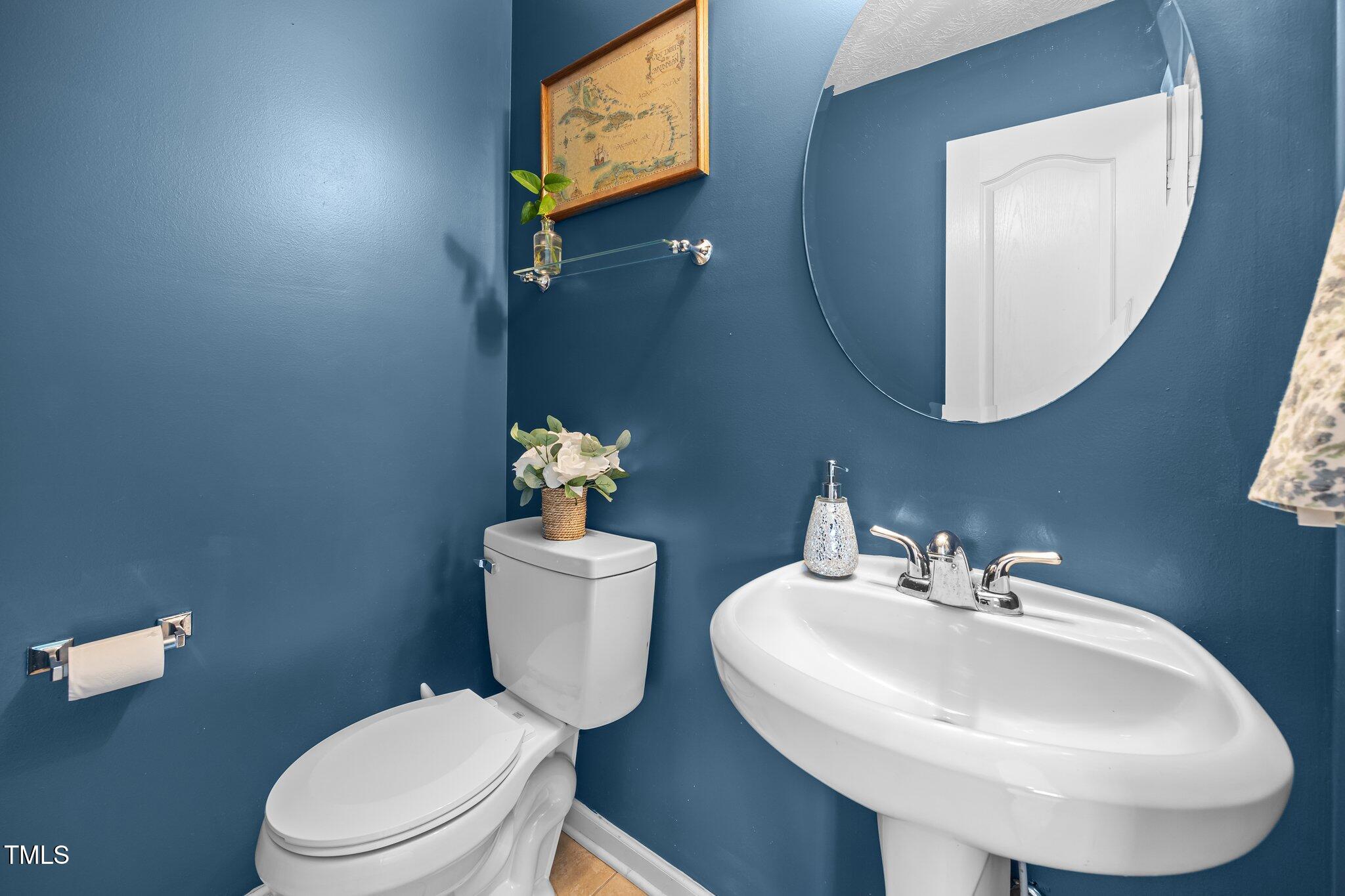 76 Haywood Street Spring Lake, NC 28390 - Photo 12 of 28 a bathroom with a toilet a sink and mirror