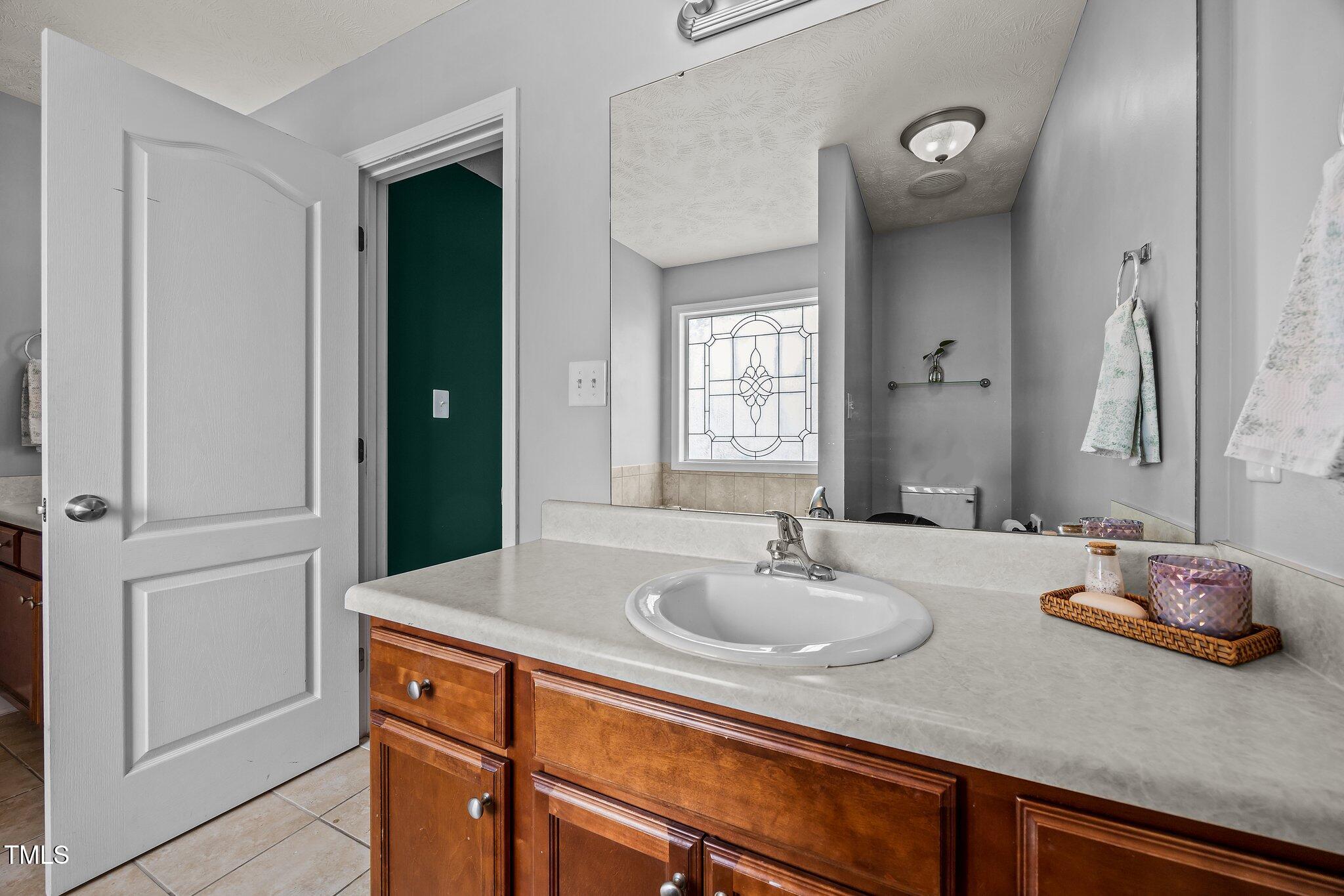76 Haywood Street Spring Lake, NC 28390 - Photo 15 of 28 a bathroom with a sink and a mirror