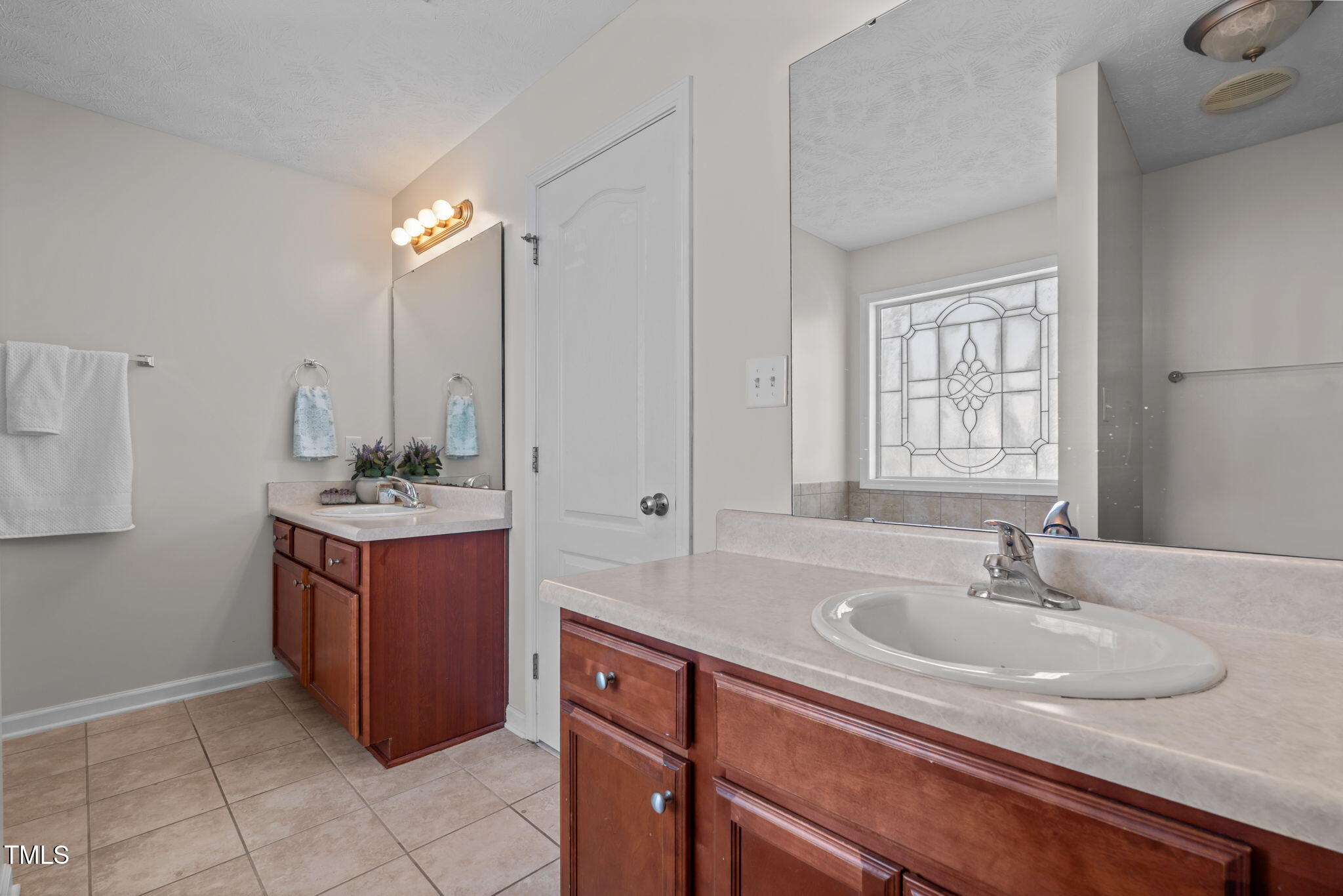 76 Haywood Street Spring Lake, NC 28390 - Photo 16 of 28 a bathroom with a granite countertop sink and a mirror
