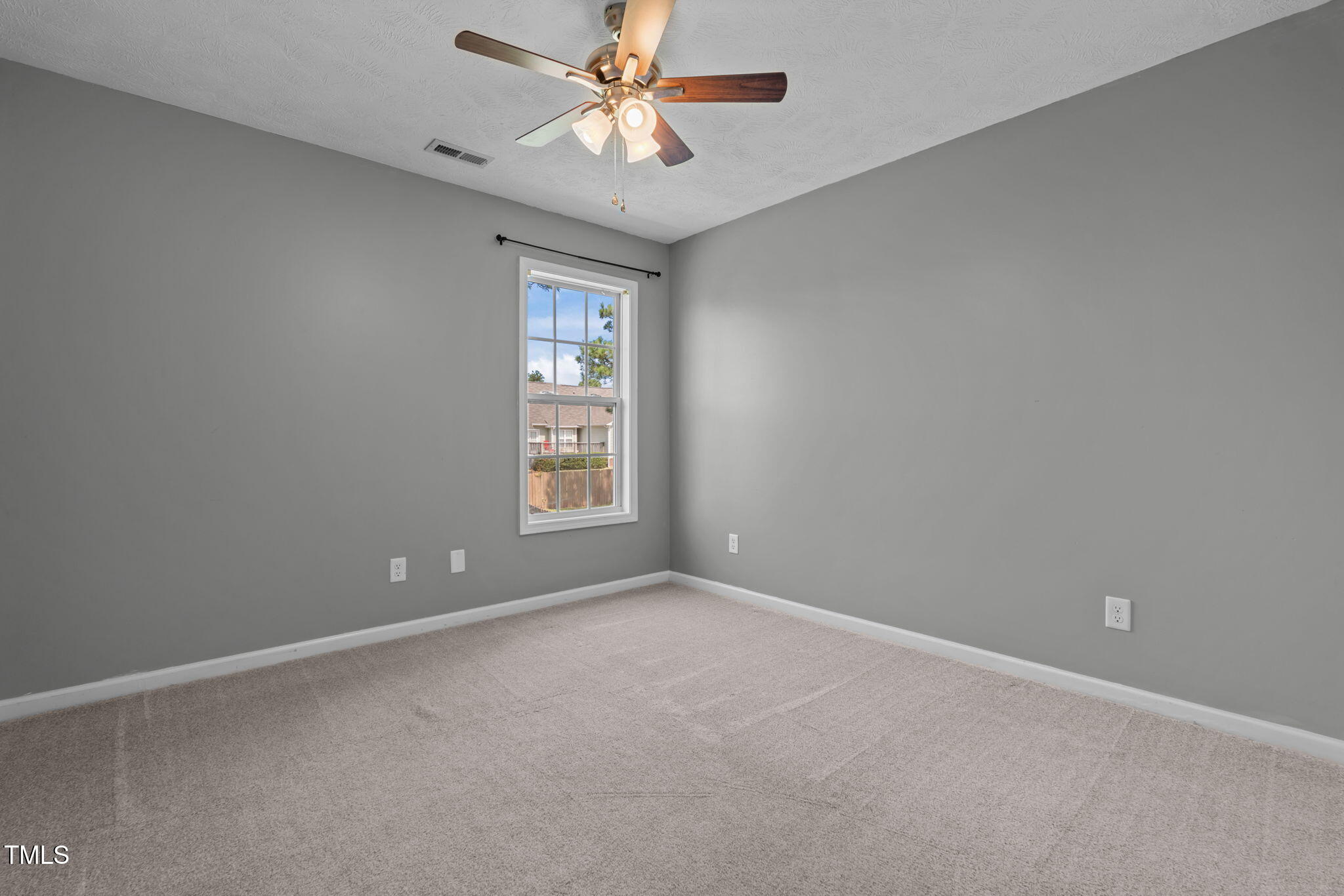 76 Haywood Street Spring Lake, NC 28390 - Photo 17 of 28 an empty room with windows and fan