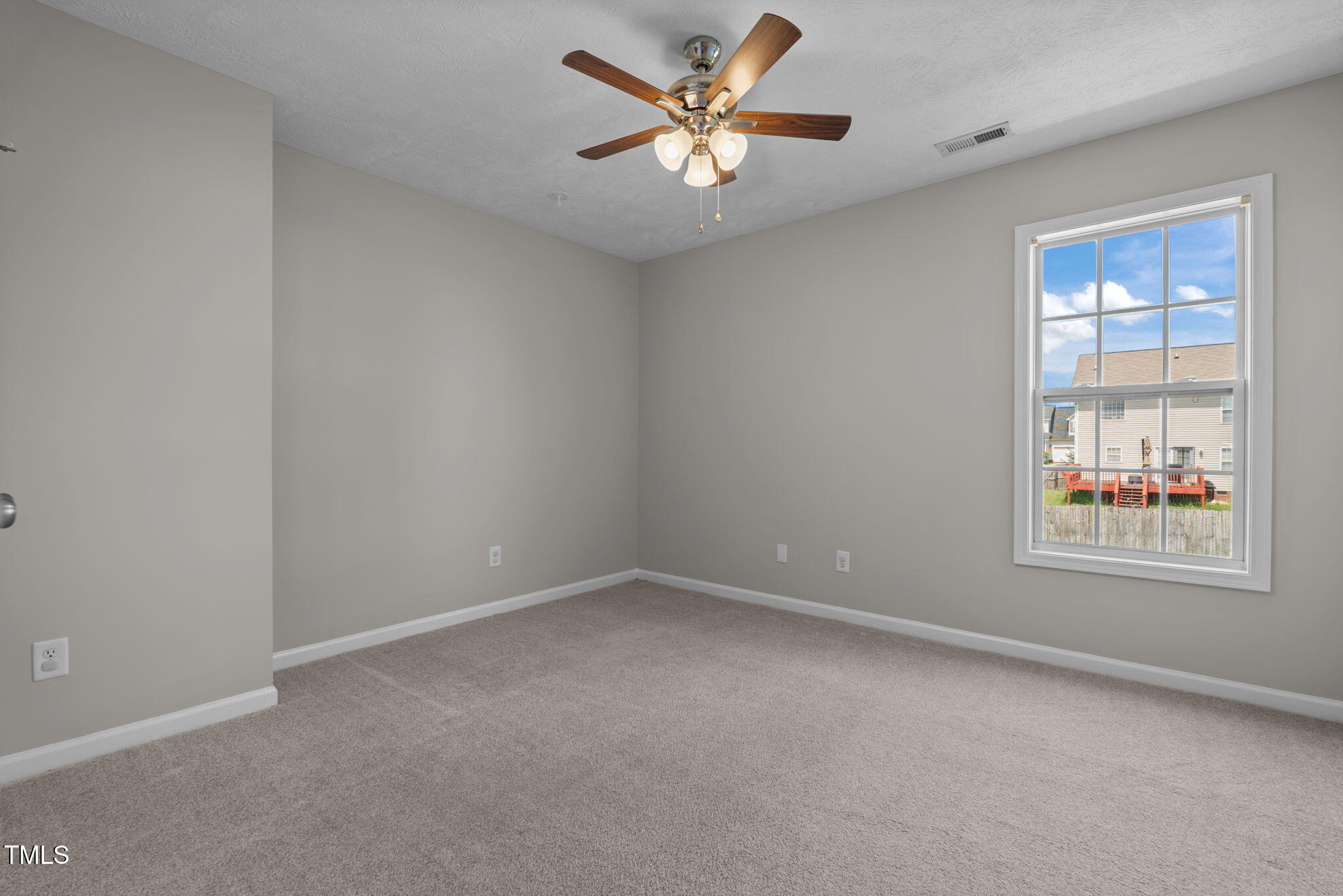 76 Haywood Street Spring Lake, NC 28390 - Photo 19 of 28 an empty room with windows and fan