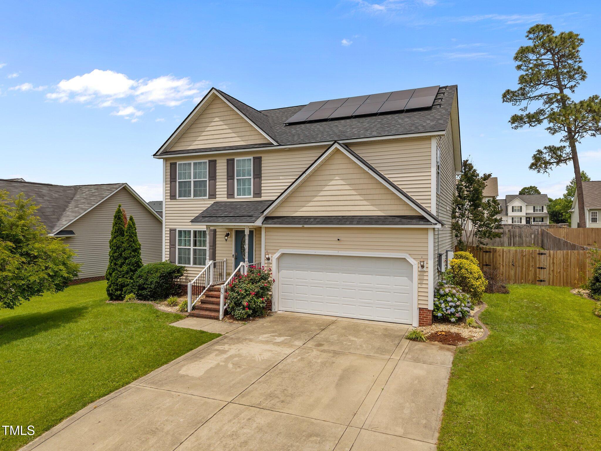 76 Haywood Street Spring Lake, NC 28390 - Photo 2 of 28 a front view of a house with a yard and garage