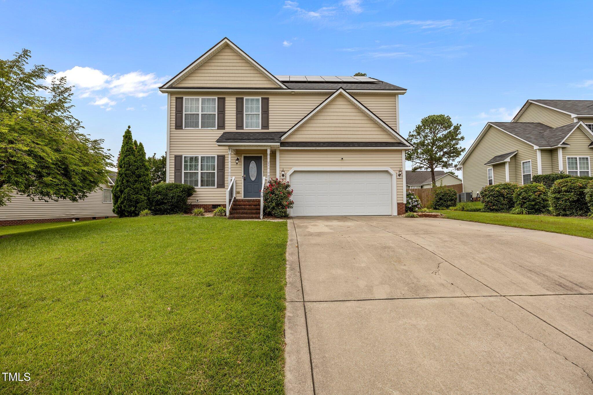 76 Haywood Street Spring Lake, NC 28390 - Photo 26 of 28 a front view of a house with a yard and garage