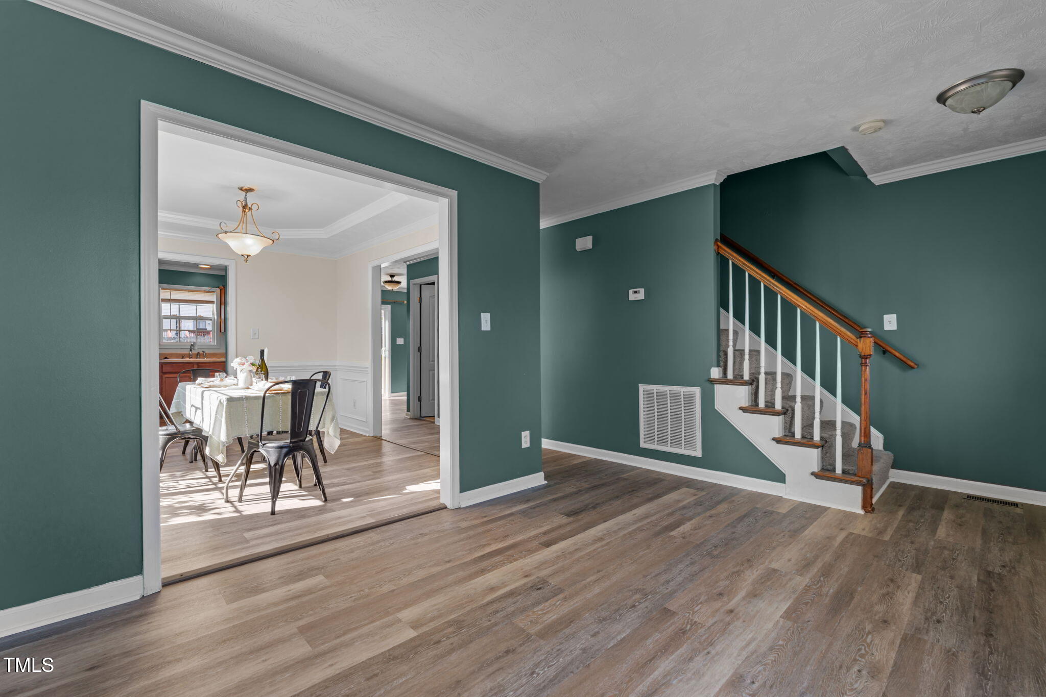 76 Haywood Street Spring Lake, NC 28390 - Photo 3 of 28 a view of a hallway with wooden floor and staircase
