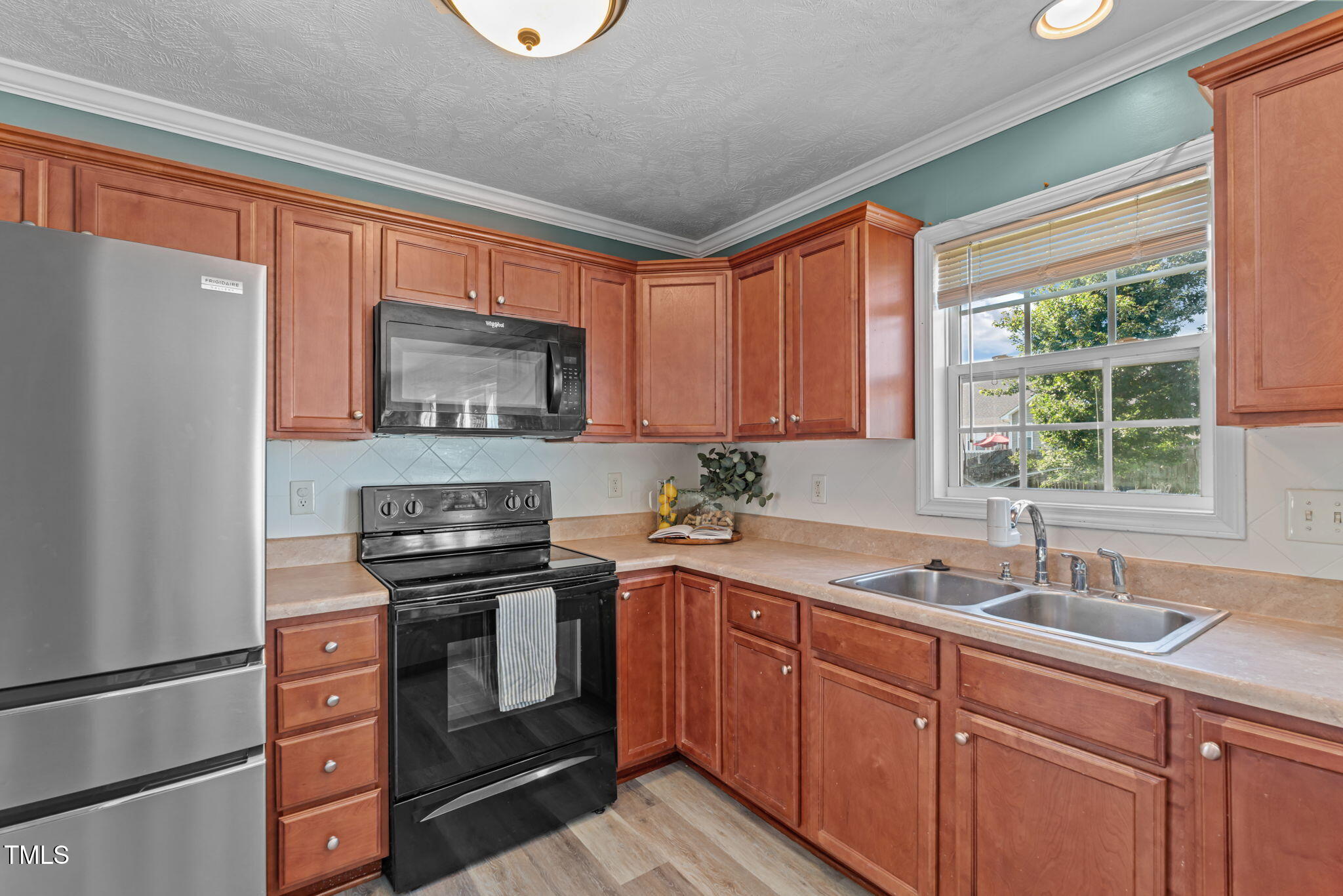 76 Haywood Street Spring Lake, NC 28390 - Photo 7 of 28 a kitchen with granite countertop a sink stainless steel appliances and window