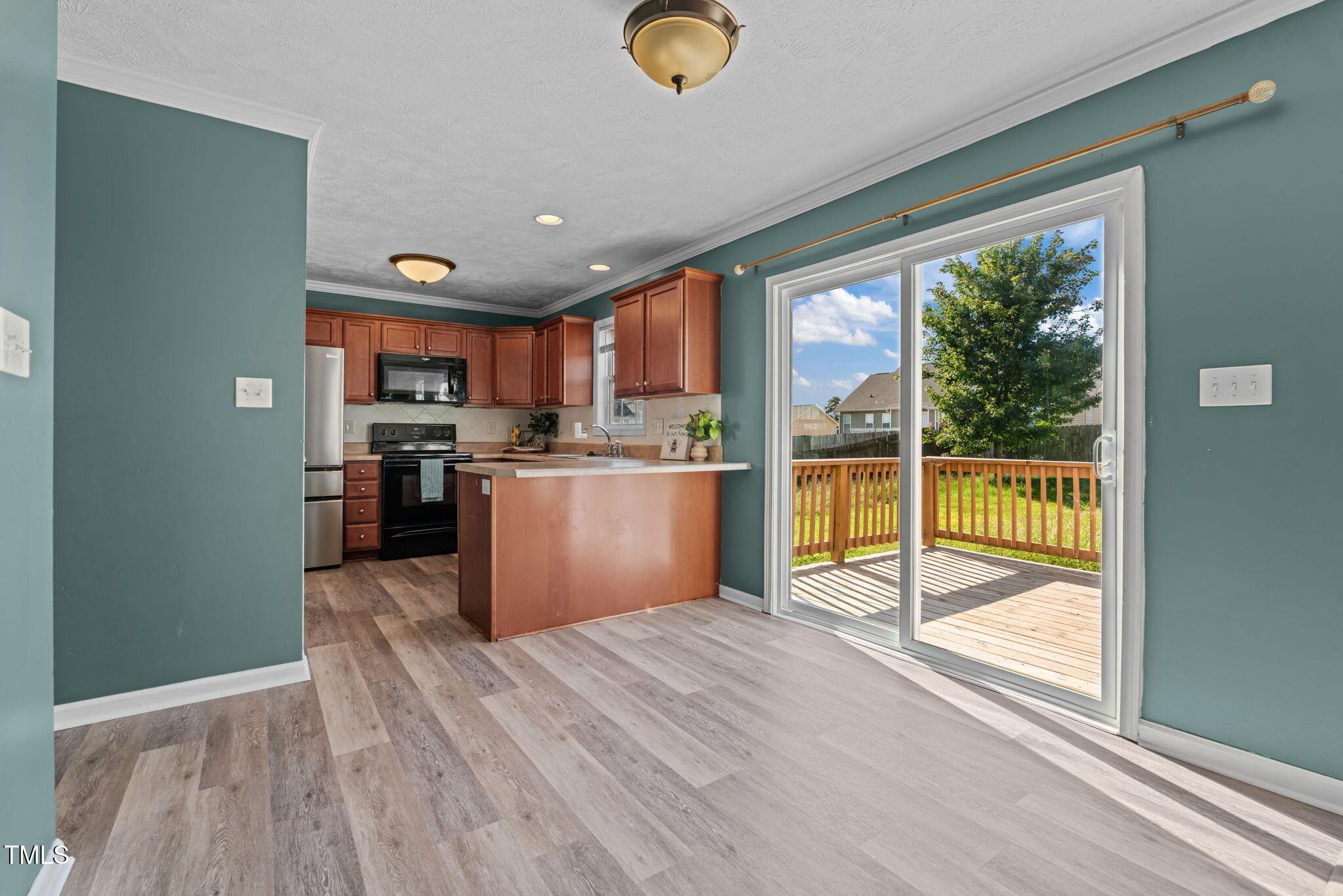 76 Haywood Street Spring Lake, NC 28390 - Photo 9 of 28 a view of a kitchen with wooden floor and a window