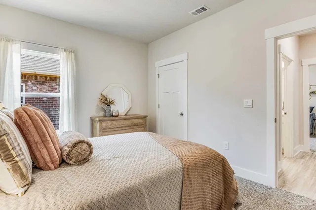 a bedroom with a bed and a window