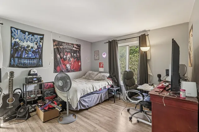 a bedroom with bed and a flat screen tv