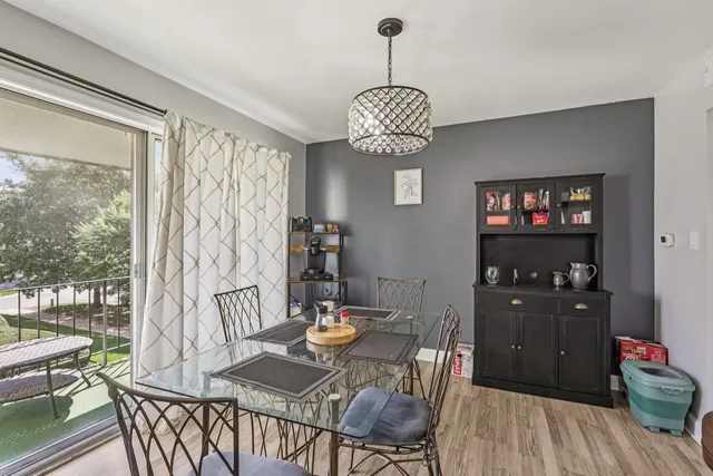 a view of a dining room with furniture wooden floor and a chandelier
