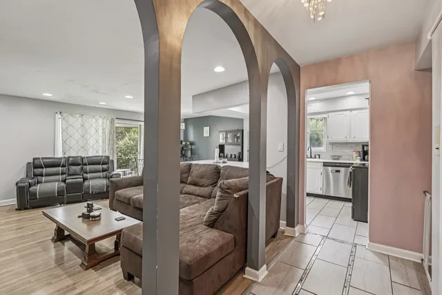 a living room with furniture and kitchen view