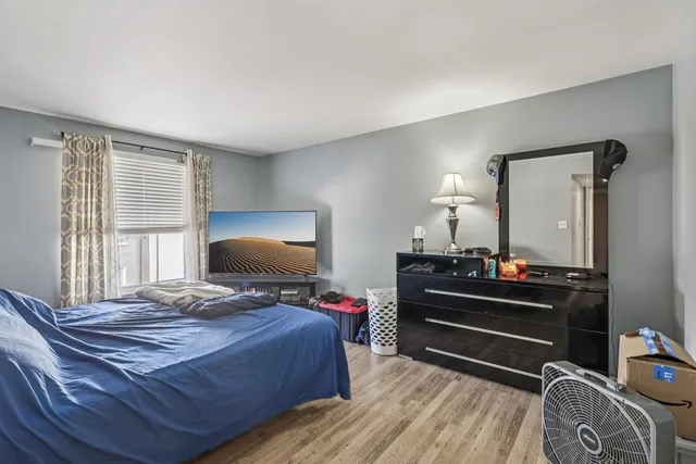 a bedroom with a bed and a dresser