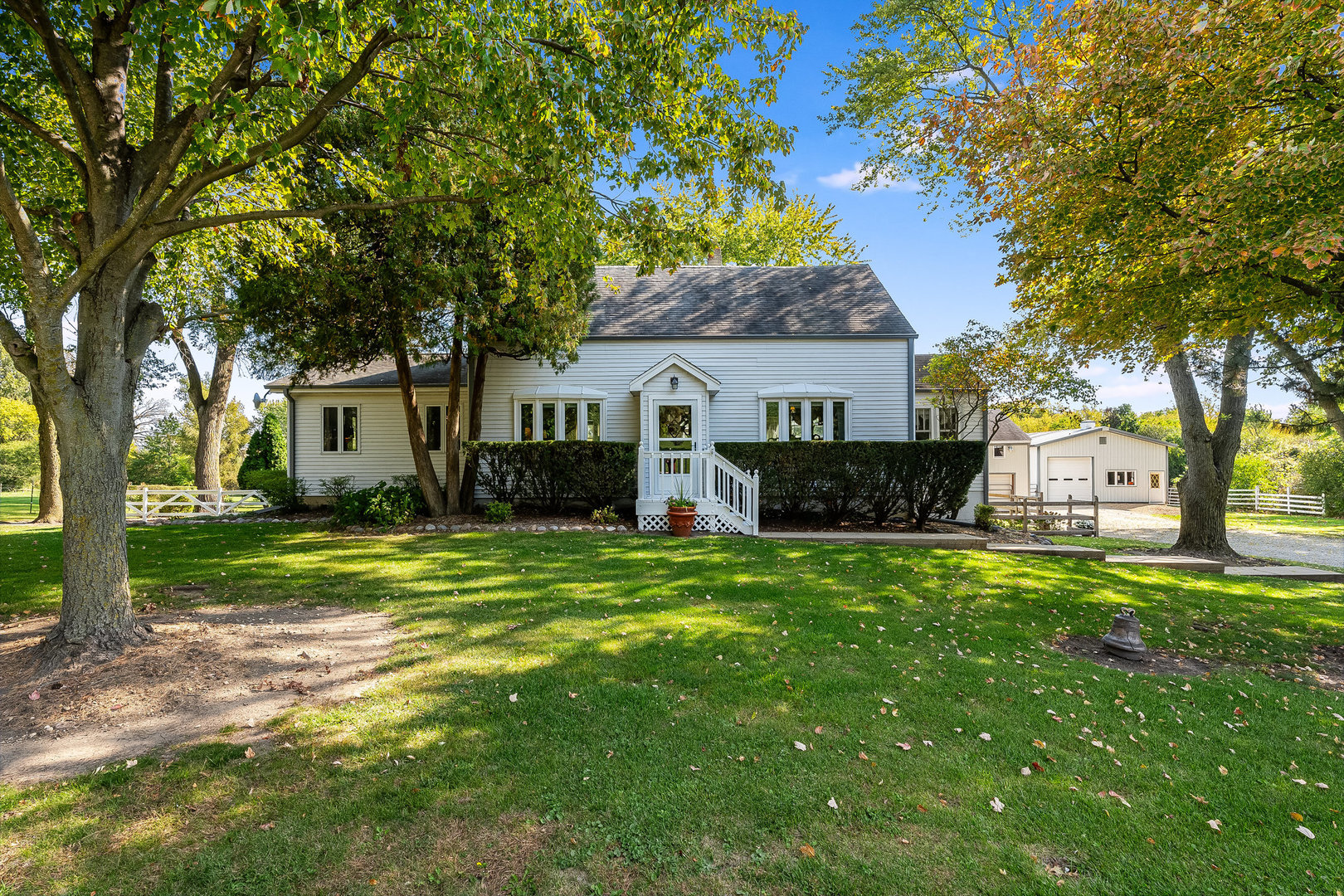 a front view of house with yard and green space