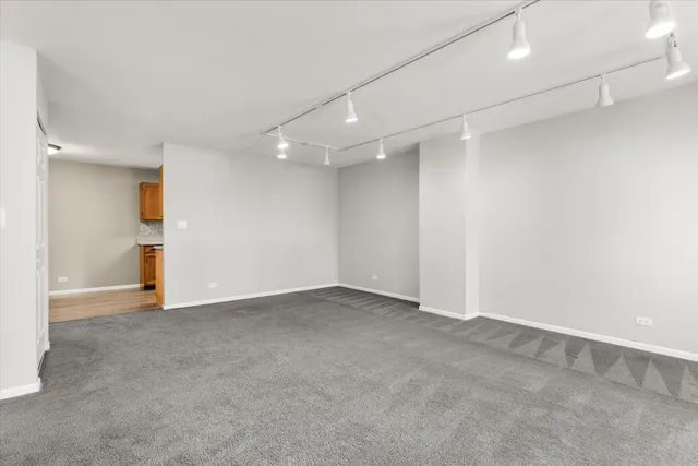 an empty room with windows & a ceiling fan view