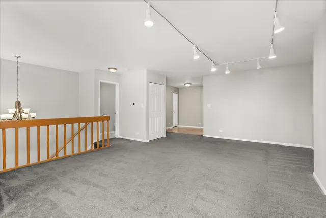 an empty room with windows and entrance