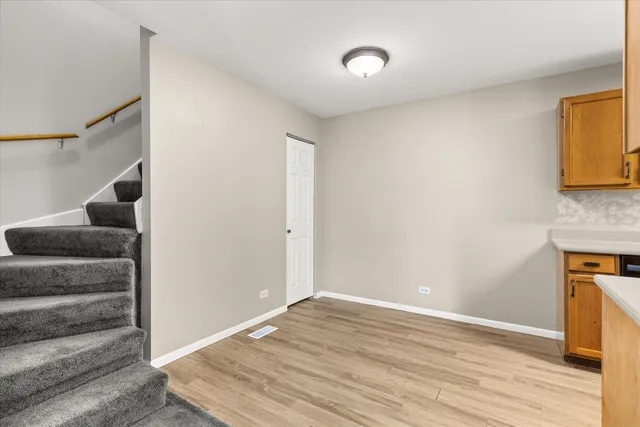 a kitchen with a sink cabinets and wooden floor