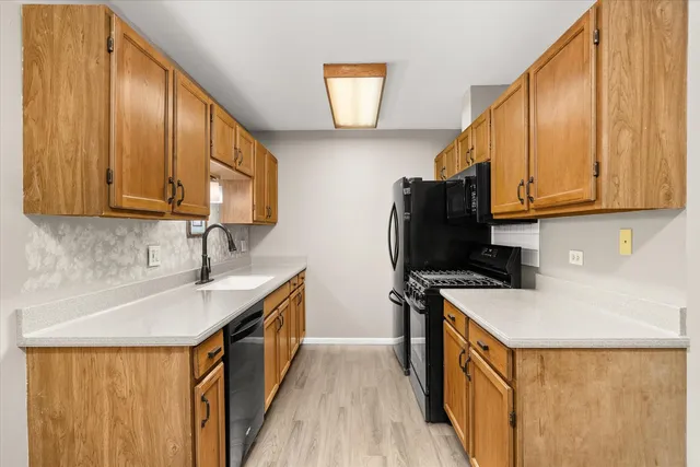 a kitchen with a refrigerator and a sink