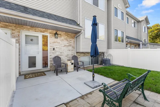 a view of backyard of house with outdoor seating