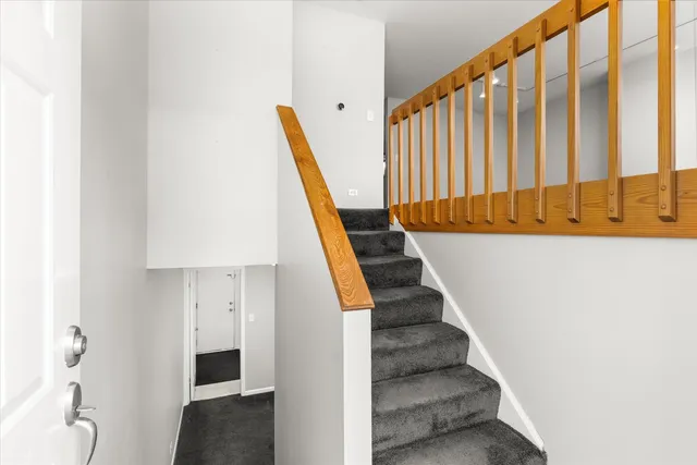 a view of entryway with wooden floor and stairs