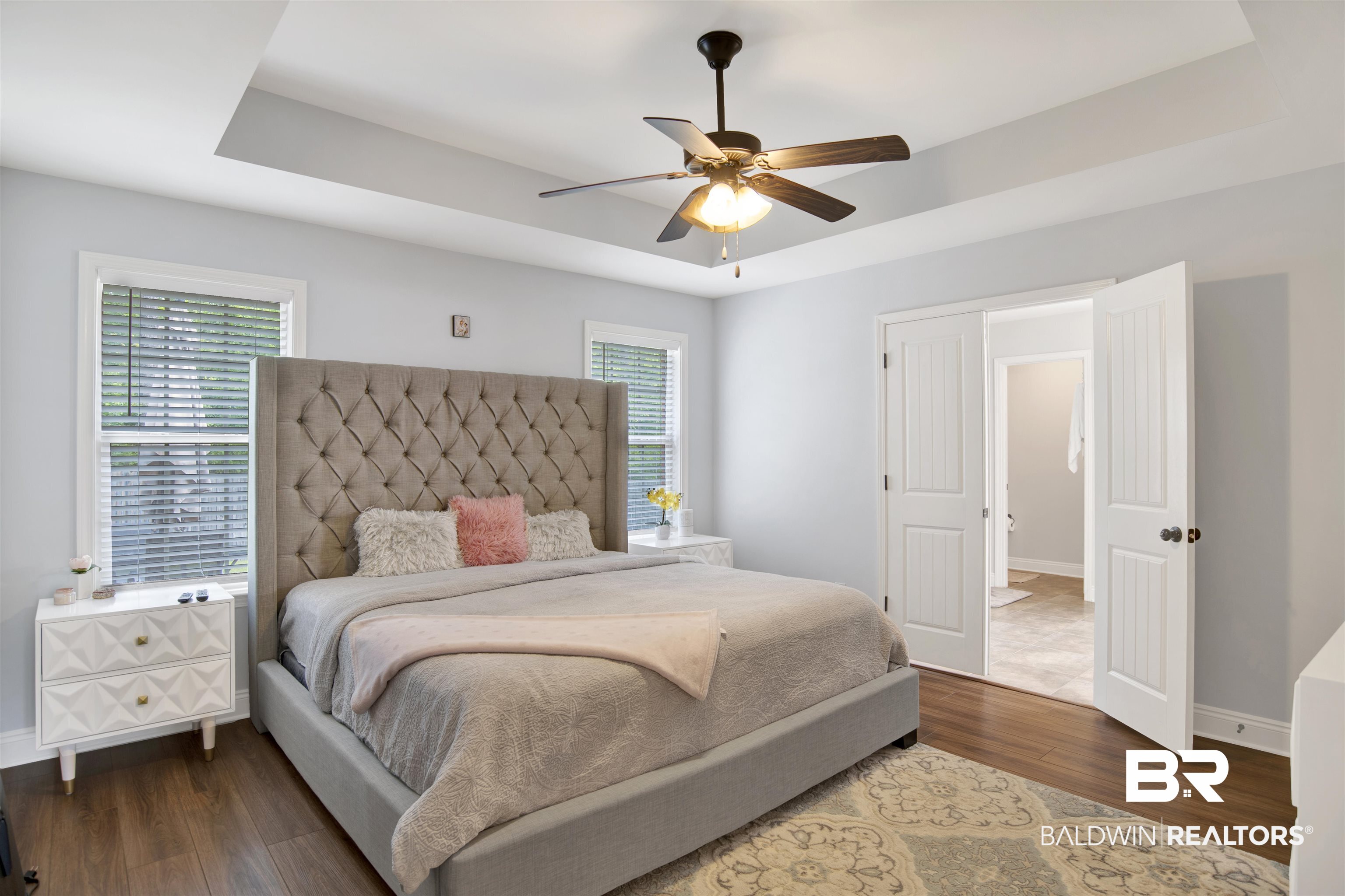 8542 Three Dean Way Mobile, AL 36695 - Photo 14 of 26 Bedroom with a tray ceiling, dark wood-type flooring, multiple windows, and baseboards