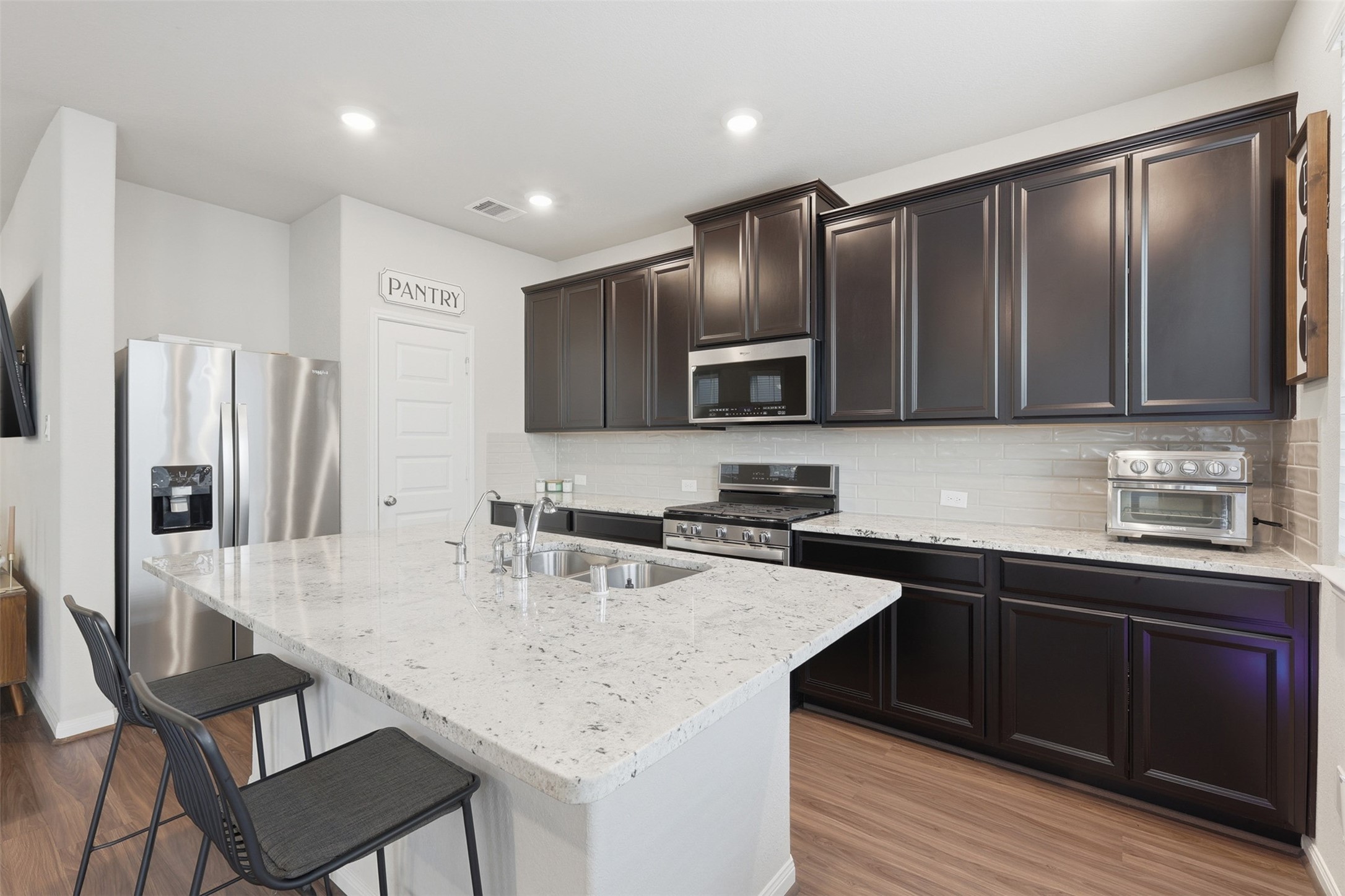 5415 Cuerta Street Houston, TX 77023 - Photo 11 of 25 a kitchen with appliances cabinets and furniture