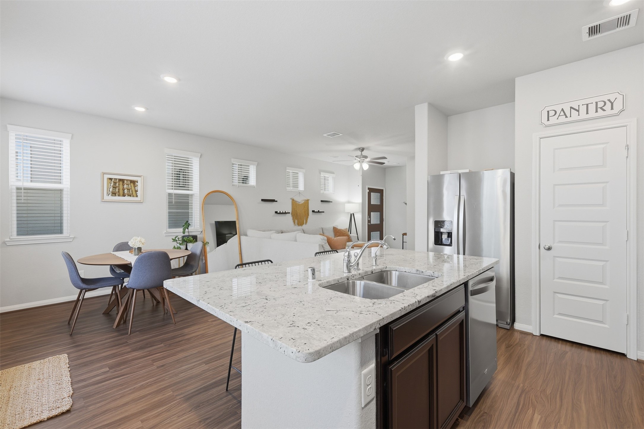 5415 Cuerta Street Houston, TX 77023 - Photo 12 of 25 a open kitchen with stainless steel appliances granite countertop a table chairs and a refrigerator