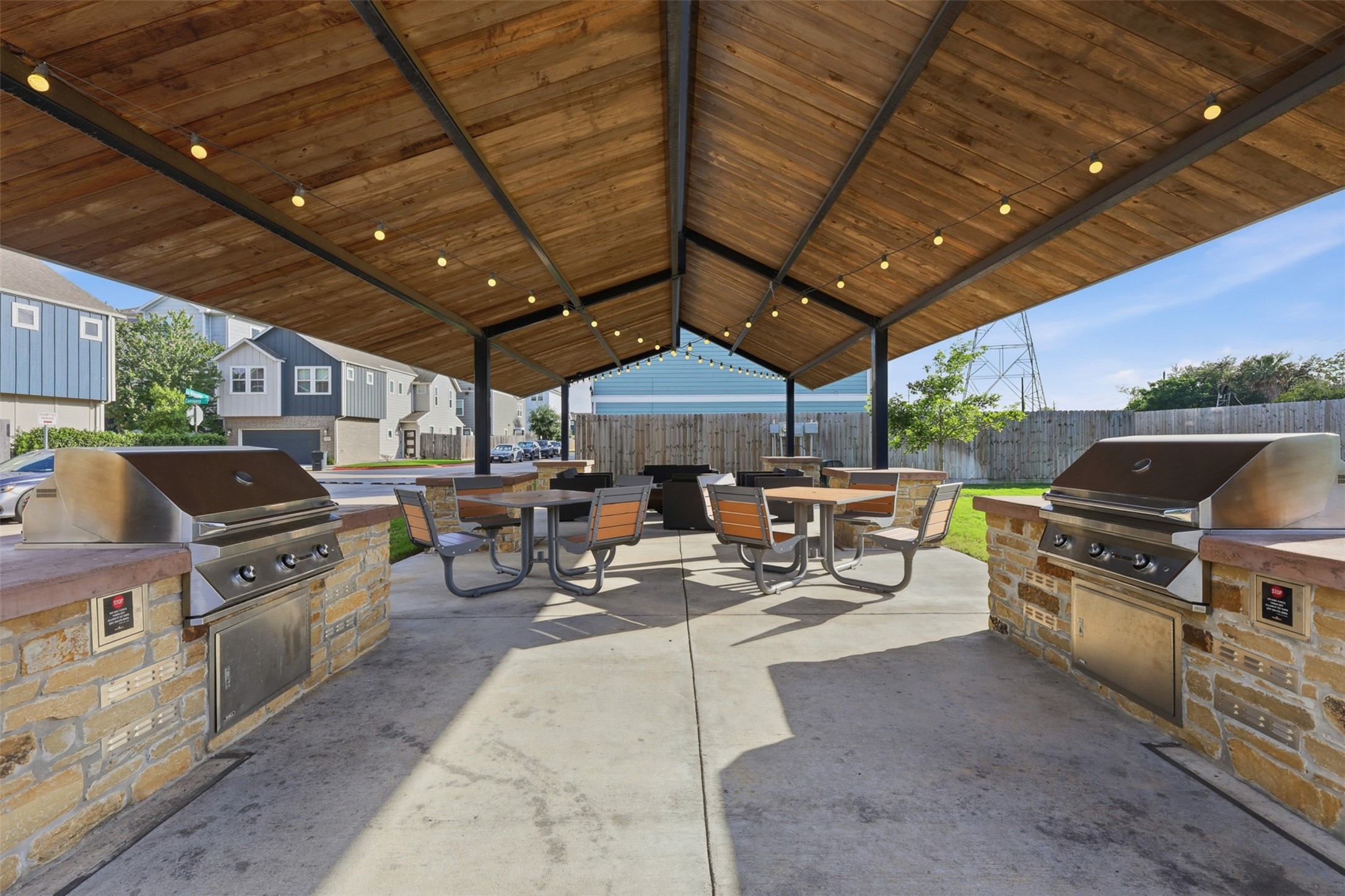 5415 Cuerta Street Houston, TX 77023 - Photo 23 of 25 a view of a patio with table and chairs under an umbrella with a barbeque