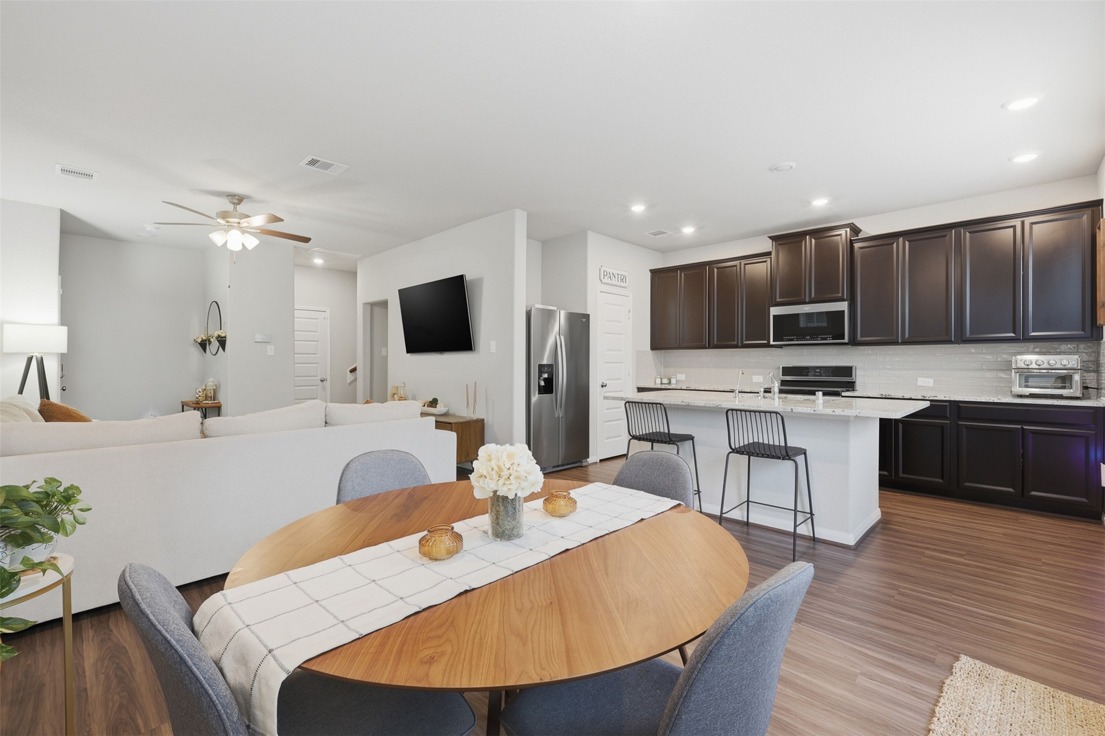 5415 Cuerta Street Houston, TX 77023 - Photo 7 of 25 a large kitchen with kitchen island a stove a sink a microwave a dining table and chairs