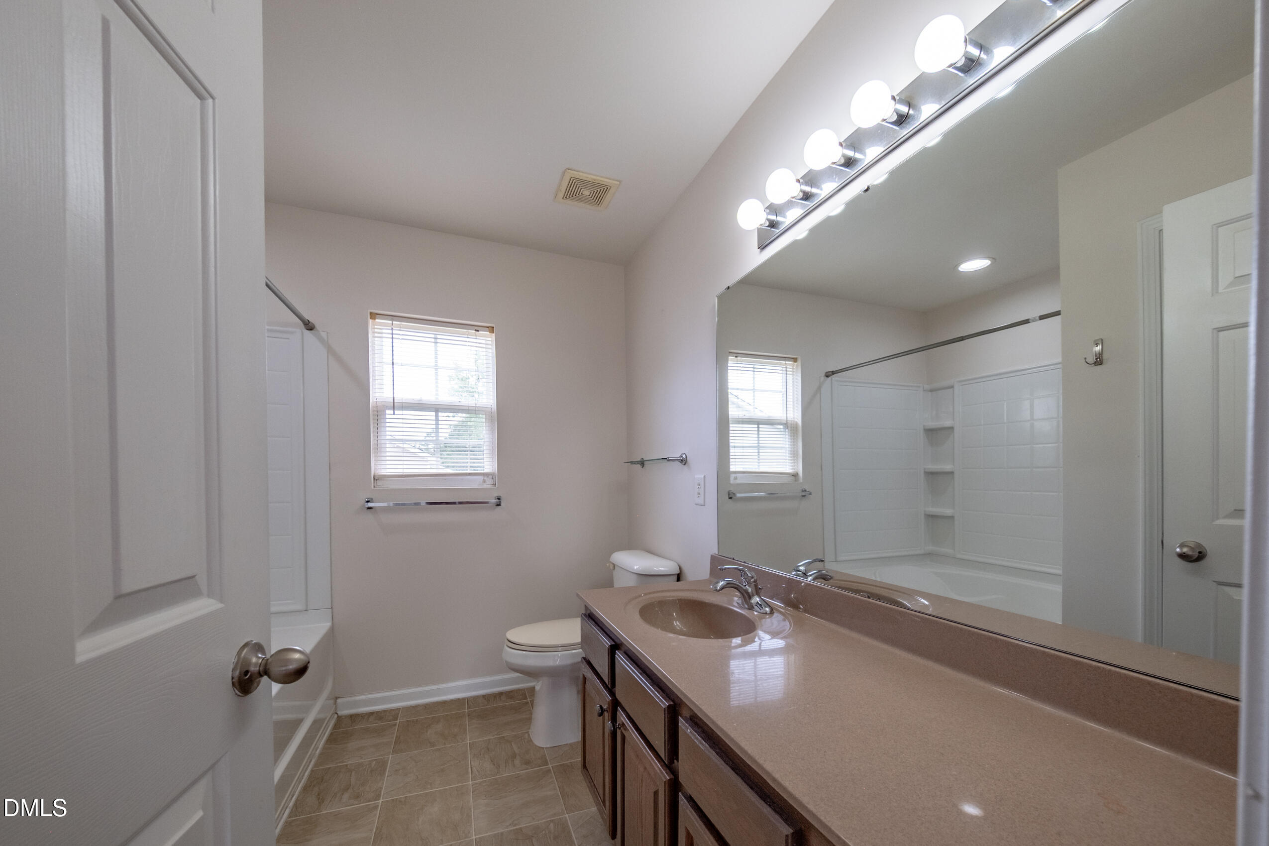 719 Obsidian Way Durham, NC 27703 - Photo 35 of 41 a bathroom with a tub a sink and mirror