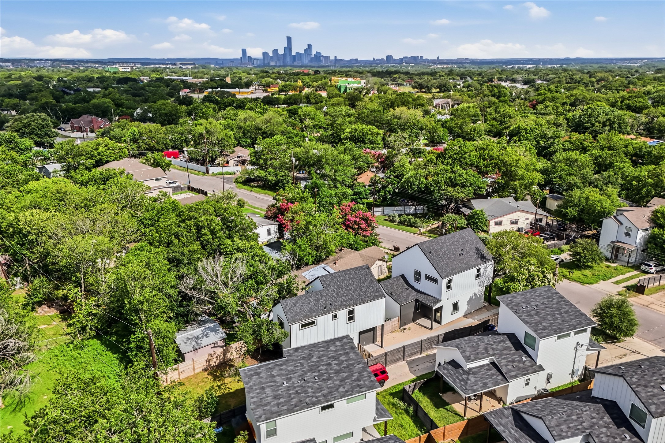 6809 Porter Street, Unit 1 Austin, TX 78741 - Photo 37 of 40 An aerial perspective reveals a tree-filled neighborhood with distant city skyline views downtown ATX.