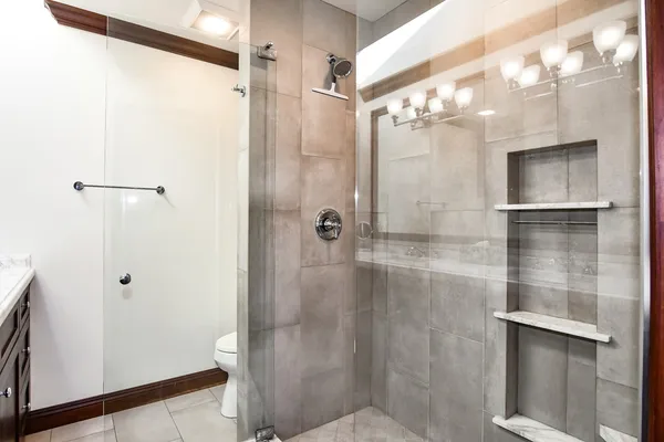 a bathroom with a glass shower door and a sink