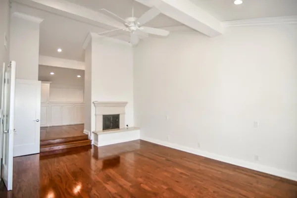 wooden floor in an empty room with a fireplace