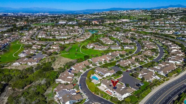 an aerial view of a residential houses with outdoor space and street view