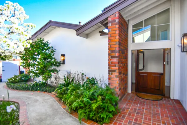 a view of front door and potted plants